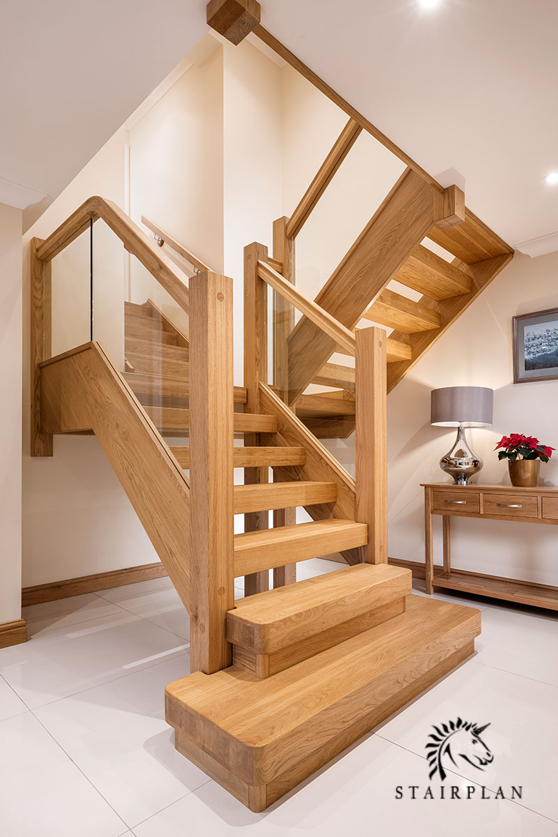 Oak townsend feature staircase with embedded glass balustrade panels