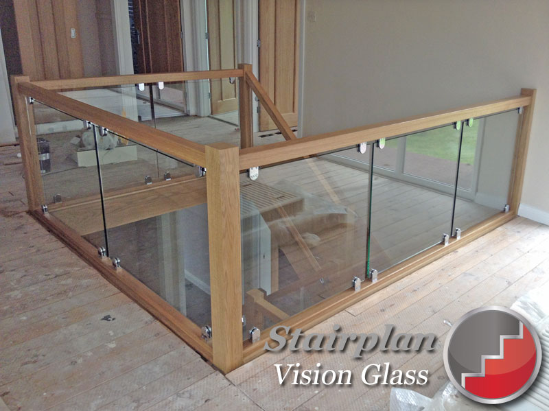 Vision Glass Balustrade Panels with oak handrail and glass clamp fixings