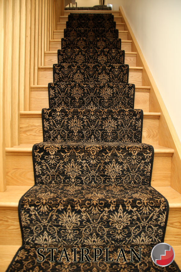 Oak staircase with a carpet runner.