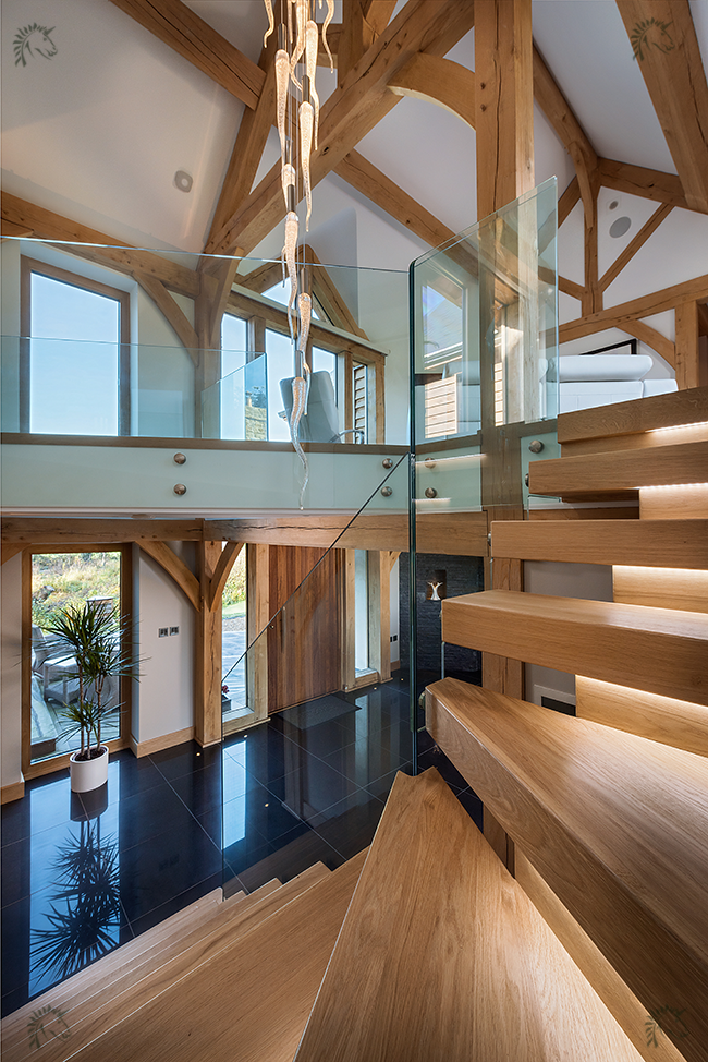 oak x vision staircase with frameless glass balustrade to stair and landing.