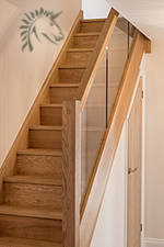 Preston oak staircase with a glass balustrade infill