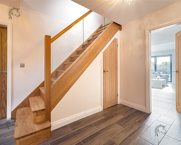 solid oak staircase with glass blustrade infill panels