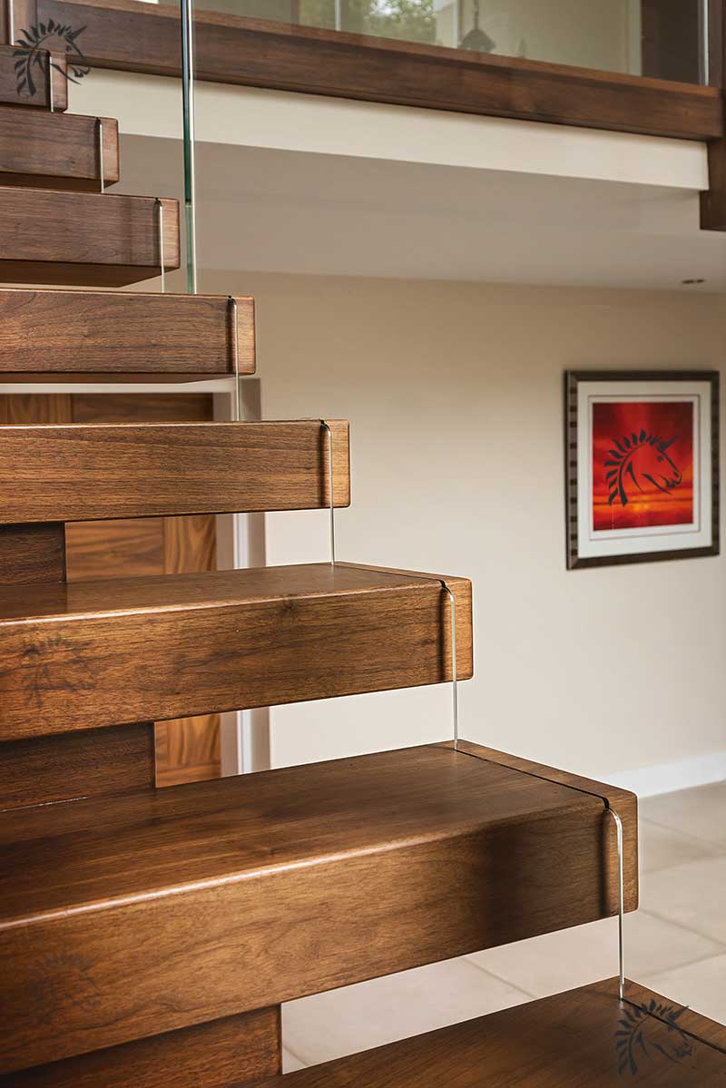 Walnut staircases with embedded glass