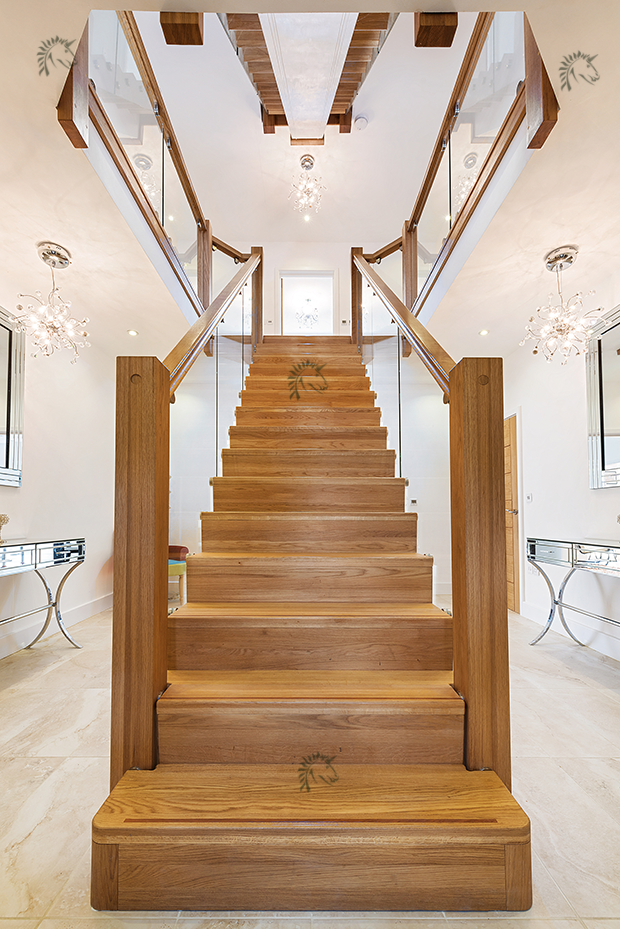 central feature oak staircase glass balustrades to both sides